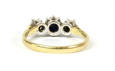 Lot 199 - An 18ct gold three stone sapphire and diamond ring