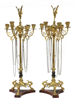 Lot 859 - A pair of bronze candelabra