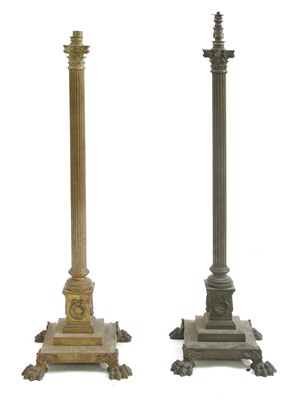Lot 881 - A near pair of brass Corinthian column standard lamps