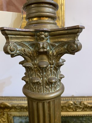Lot 881 - A near pair of brass Corinthian column standard lamps