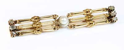 Lot 124 - An early 20th century pearl and diamond bar brooch