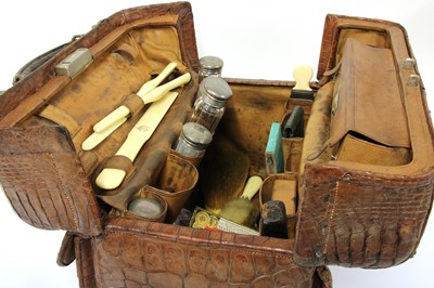 Lot 148 - A crocodile skin travelling vanity case