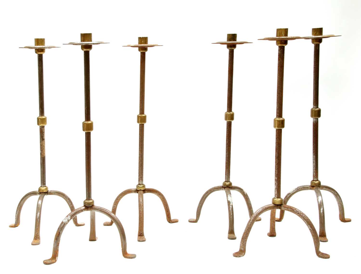 Lot 117 - A set of six steel and brass candlesticks