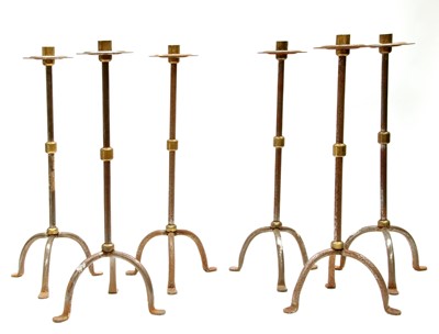 Lot 117 - A set of six steel and brass candlesticks