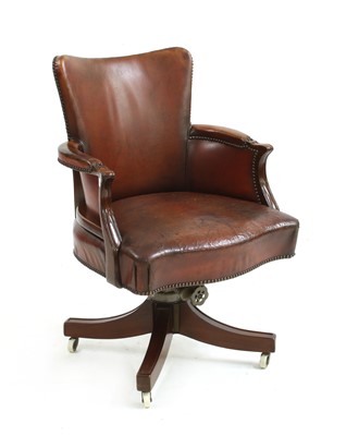 Lot 471 - A reproduction brown leather swivel armchair by 'Hillcrest'