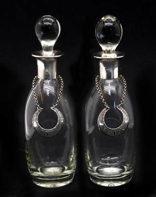 Lot 350 - A pair of early 20th century glass and silver mounted decanters
