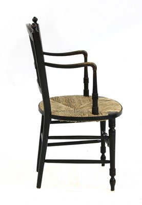 Lot 72 - A Morris & Co. ebonised elbow chair