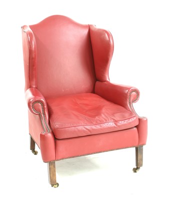 Lot 486 - A George III style wing back armchair