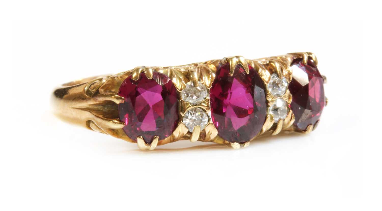 Lot 44 - A seven stone ruby and diamond carved head ring