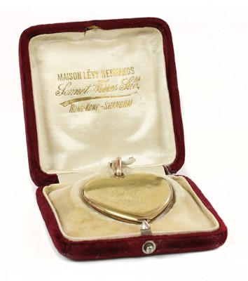 Lot 85 - A gold heart-shaped swivel locket, c.1910