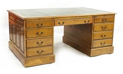 Lot 464 - An early 20th Century oak and walnut partners desk