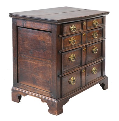 Lot 705 - A transitional oak chest of drawers