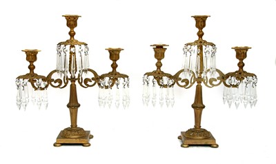 Lot 145R - A pair of gilt bronze three light candle lustres