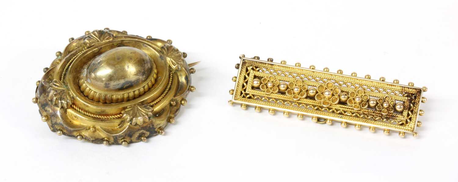 Lot 19 - A Victorian Etruscan Revival gold shield form brooch