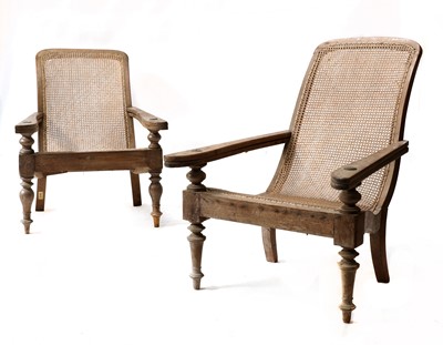 Lot 134 - A near pair of teak planter's lounge chairs