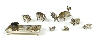 Lot 241 - A collection of silver pig novelties