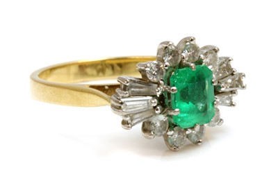 Lot 393 - A two colour gold emerald and diamond cluster ring