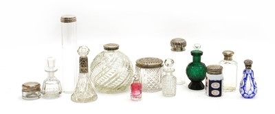 Lot 247 - A large collection of silver topped cut glass perfumes and jars