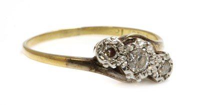 Lot 130 - A three stone diamond crossover ring