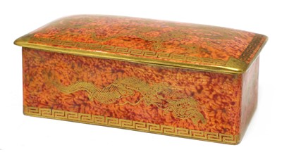 Lot 375 - A Wedgwood 'Celestial Dragon' orange lustre cigarette box and cover