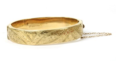 Lot 295 - A 9ct gold hollow oval hinged bangle