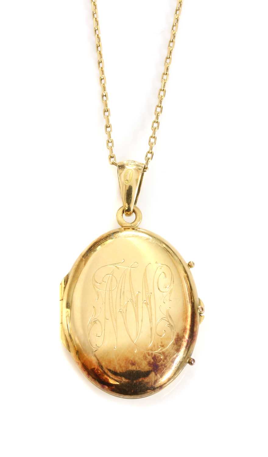 Lot 58 - A Finnish 18ct gold oval hinged locket