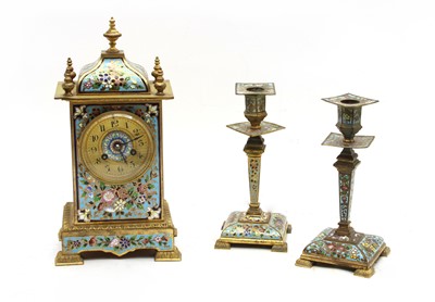 Lot 81 - A gilt metal and champleve three piece clock garniture