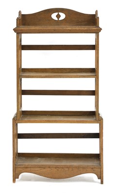 Lot 185 - An Arts and Crafts oak four-tier open bookcase