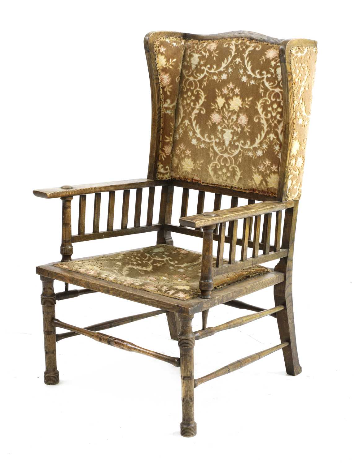 Lot 167 - An Arts and Crafts oak wingback armchair