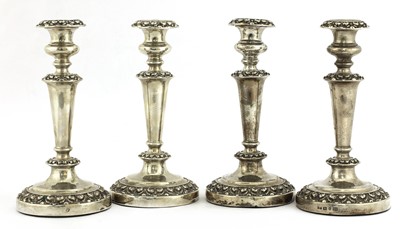 Lot 27 - A set of four William IV silver candlesticks