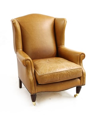 Lot 542 - A contemporary Laura Ashley brown leather wingback armchair