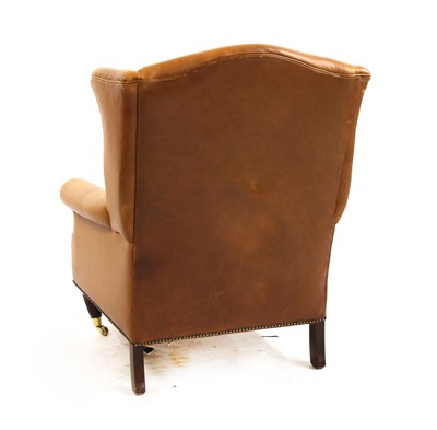 Lot 542 - A contemporary Laura Ashley brown leather wingback armchair