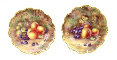 Lot 155 - A pair of Royal Worcester hard painted and gilt heightened cabinet plates