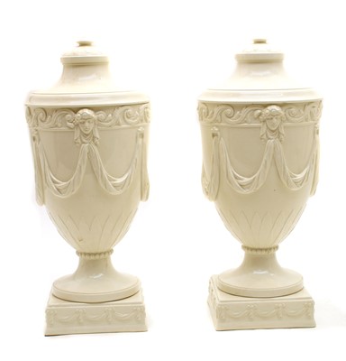Lot 137 - A pair of Wedgwood embossed Queensware urns