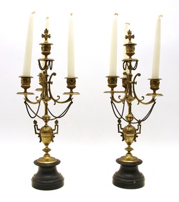Lot 260 - A pair of brass candelabra
