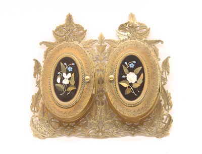 Lot 129 - An engraved and pierced brass folding photograph frame