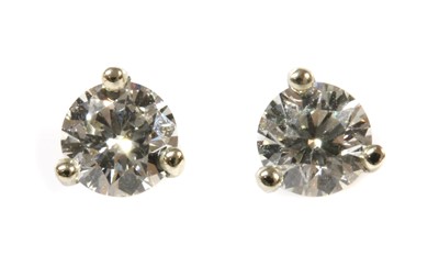 Lot 245 - A pair of white gold single stone diamond stud earrings