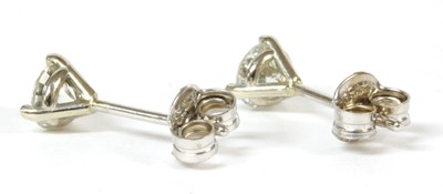 Lot 245 - A pair of white gold single stone diamond stud earrings