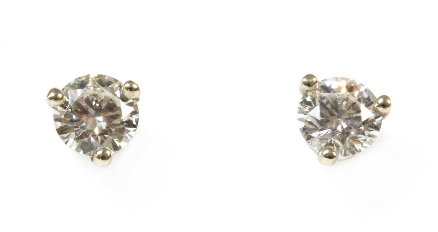 Lot 247 - A pair of white gold single stone diamond stud earrings