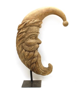 Lot 411A - A carved wooden crescent 'Man in the Moon' on stand
