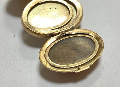 Lot 23 - A gold egg form multi-photo 'family' locket
