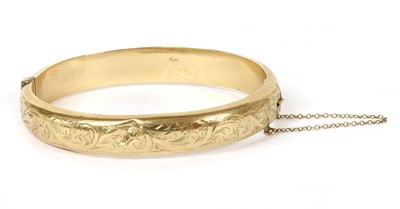 Lot 301 - A 9ct gold oval hollow hinged bangle