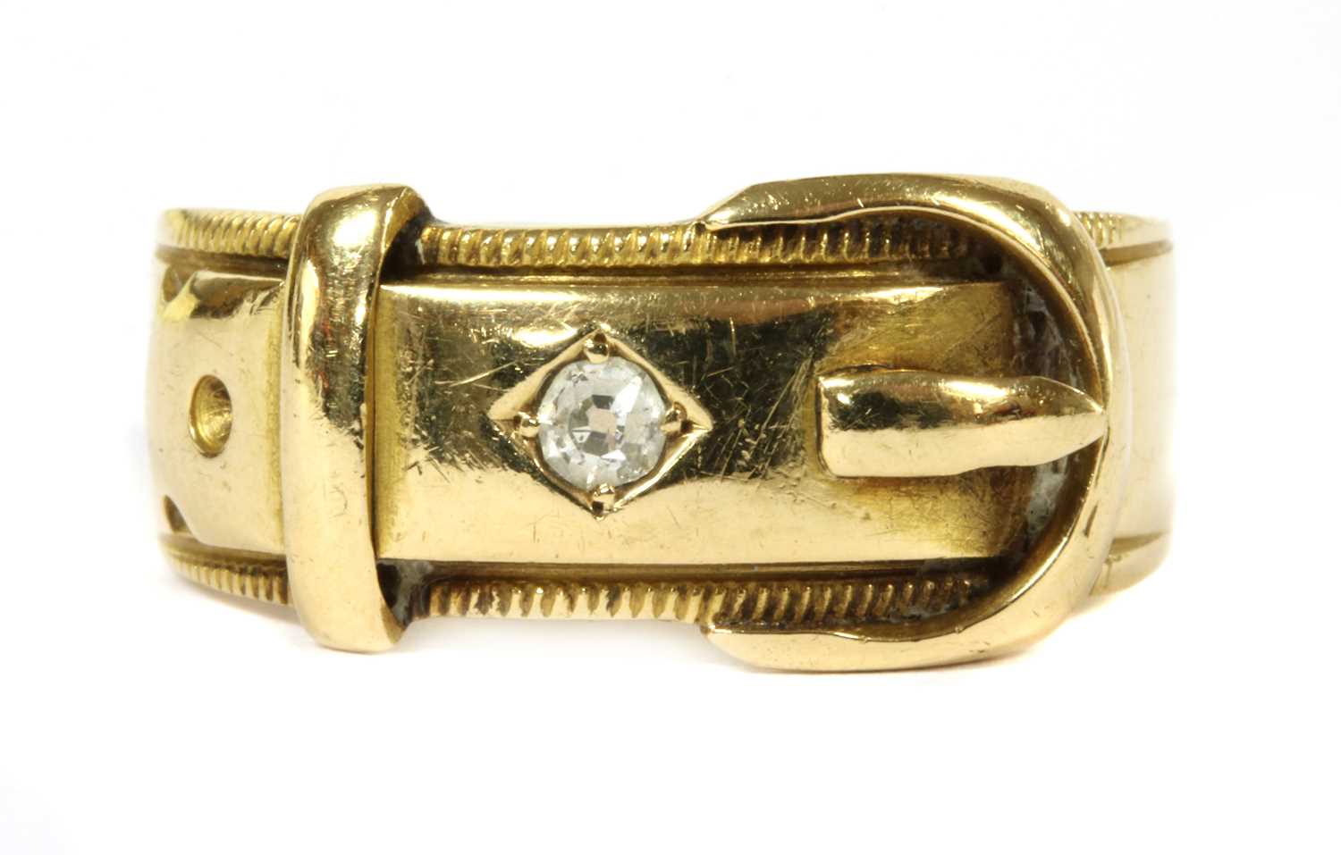 Lot 25 - An 18ct gold diamond set buckle ring