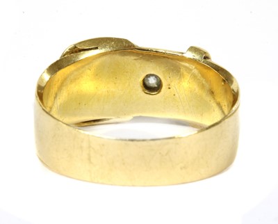Lot 25 - An 18ct gold diamond set buckle ring