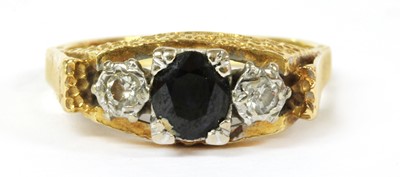 Lot 144 - An 18ct gold sapphire and diamond three stone ring