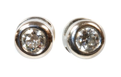 Lot 409 - A pair of 18ct white gold single stone diamond earrings by Theo Fennell