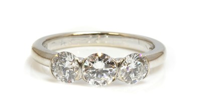 Lot 410 - A three stone diamond ring by Theo Fennell