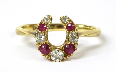 Lot 51 - A gold diamond and ruby horseshoe ring