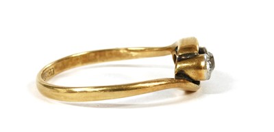 Lot 161 - A gold three stone diamond crossover ring