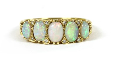 Lot 205 - An 18ct gold five stone opal carved head style ring